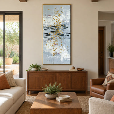 Gentle Measure ivory gold relief wall art with a gold frame hanging in a living room