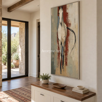 Woven Trace ivory horse art with a silver frame in an entryway