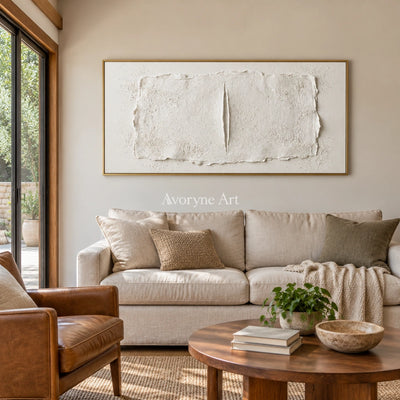Woven Cadence ivory layered relief wall art with a gold frame hanging in a living room