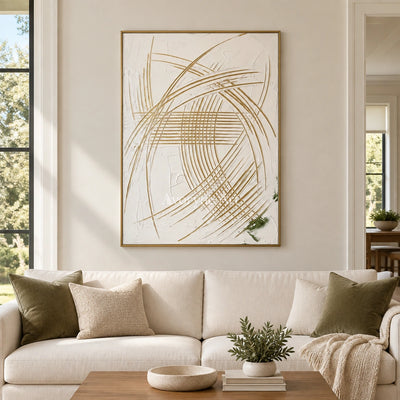 Silver Reverberation linear abstract wall art with a gold frame hanging in a living room