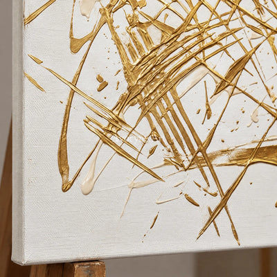 Close-up of the hand-painted texture of Golden Prelude linear abstract wall art on an easel