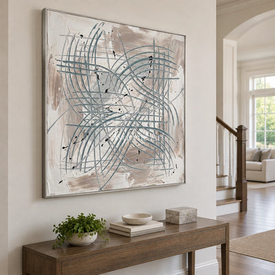 Golden Story linear abstract wall art with a silver frame in an entryway