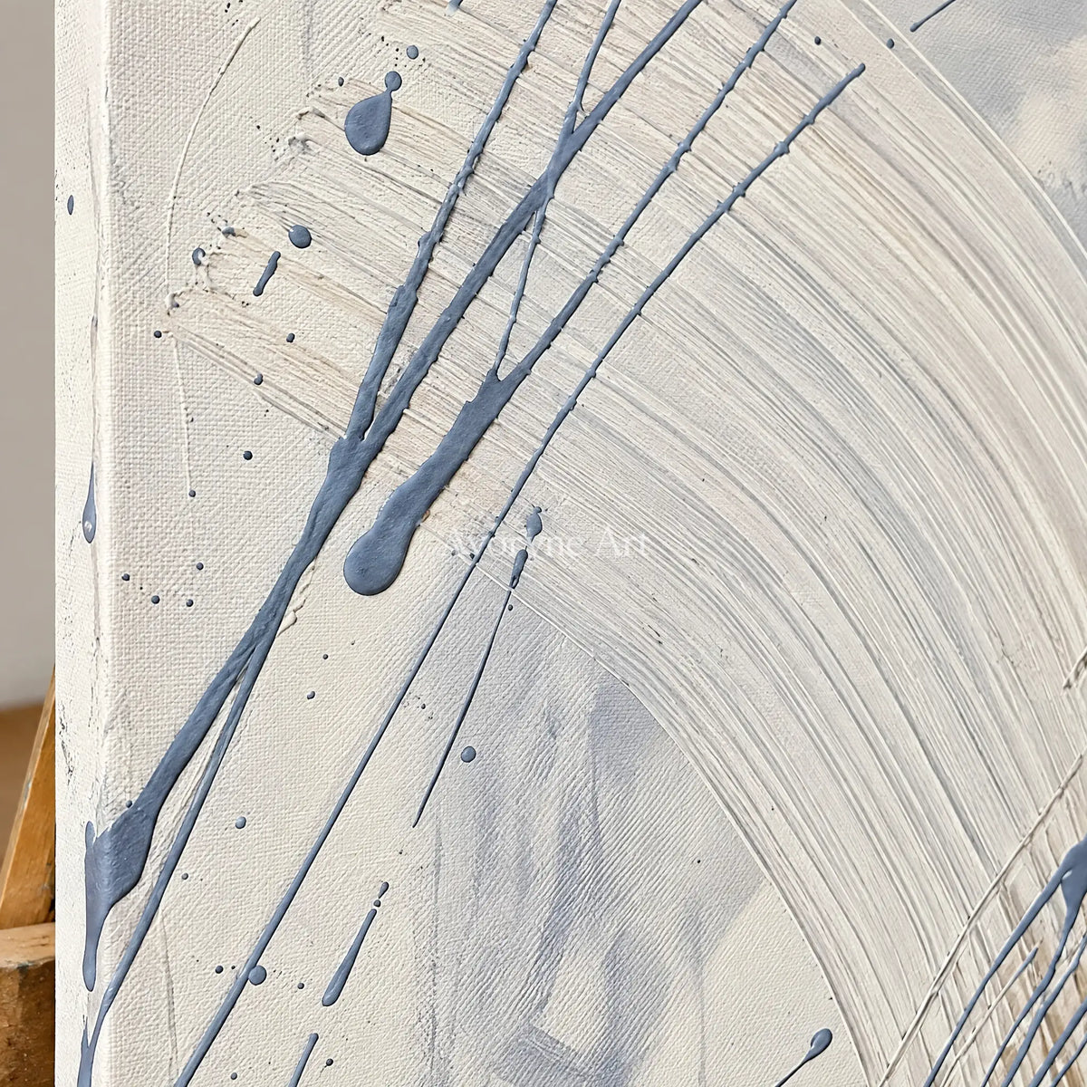 Close-up of the hand-painted texture of Golden Dialogue linear abstract wall art on an easel