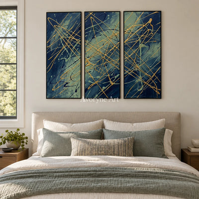 Silver Vista linear abstract triptych with a black frame above a bed in a bedroom