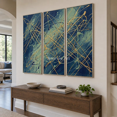 Silver Vista linear abstract triptych with a silver frame in an entryway