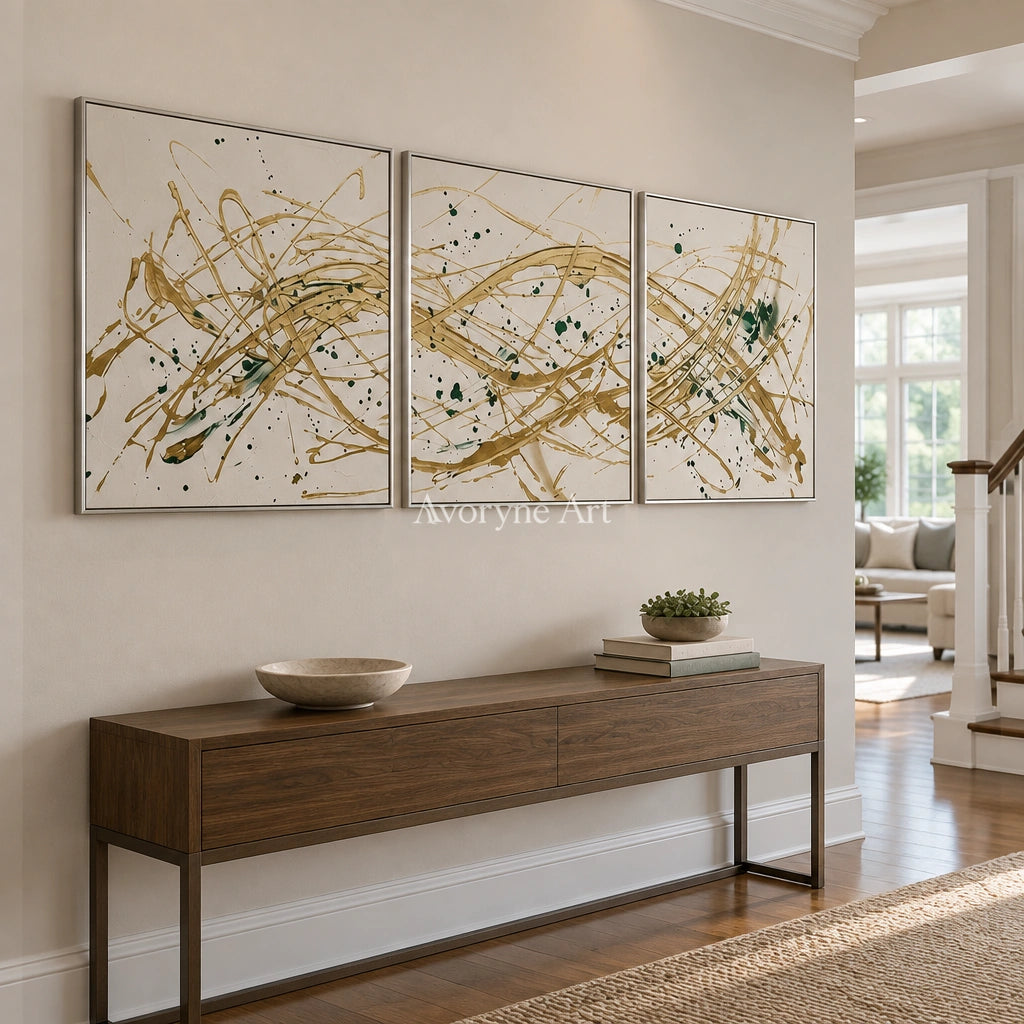 Golden Reverie linear abstract triptych with a silver frame in an entryway