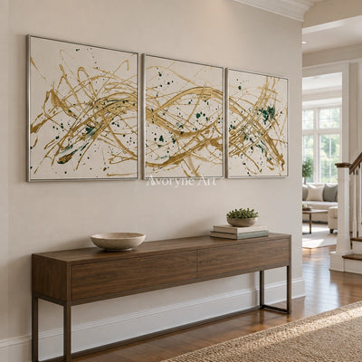 Golden Reverie linear abstract triptych with a silver frame in an entryway