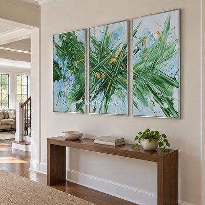 Golden Memory linear abstract triptych with a silver frame in an entryway