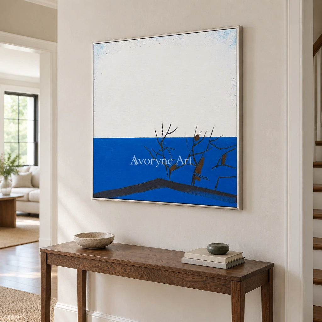 Deep Reverie minimal branch wall art with a silver frame in an entryway