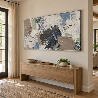 Earthen Verse muted geometric art with a silver frame in an entryway