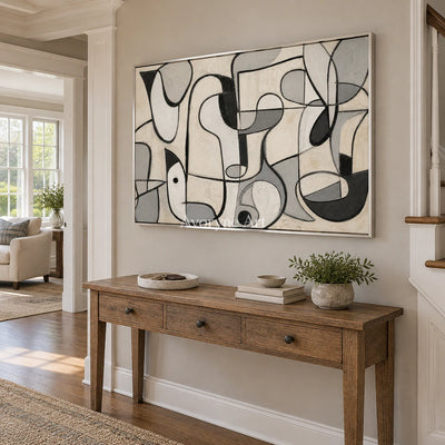 Woven Reverie muted organic abstract wall art with a silver frame in an entryway
