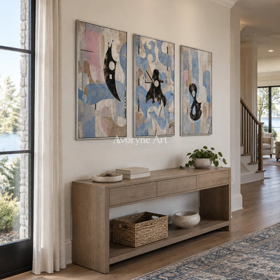 Woven Horizon muted organic abstract triptych with a silver frame in an entryway