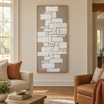 Misted Current neutral block relief wall art with a gold frame hanging in a living room