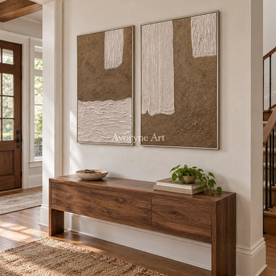 Muted Current neutral fold relief diptych with a silver frame in an entryway
