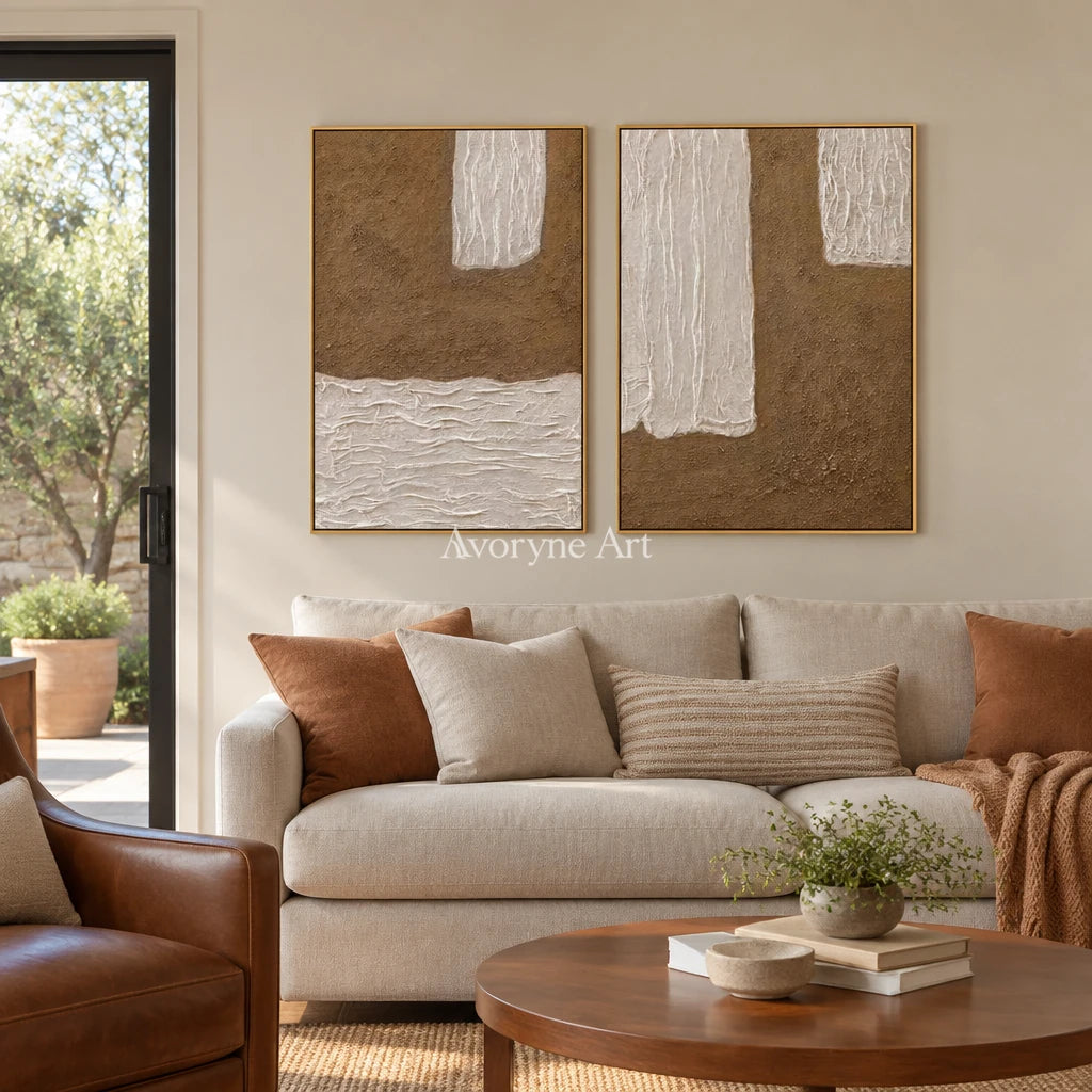 Muted Current neutral fold relief diptych with a gold frame hanging in a living room