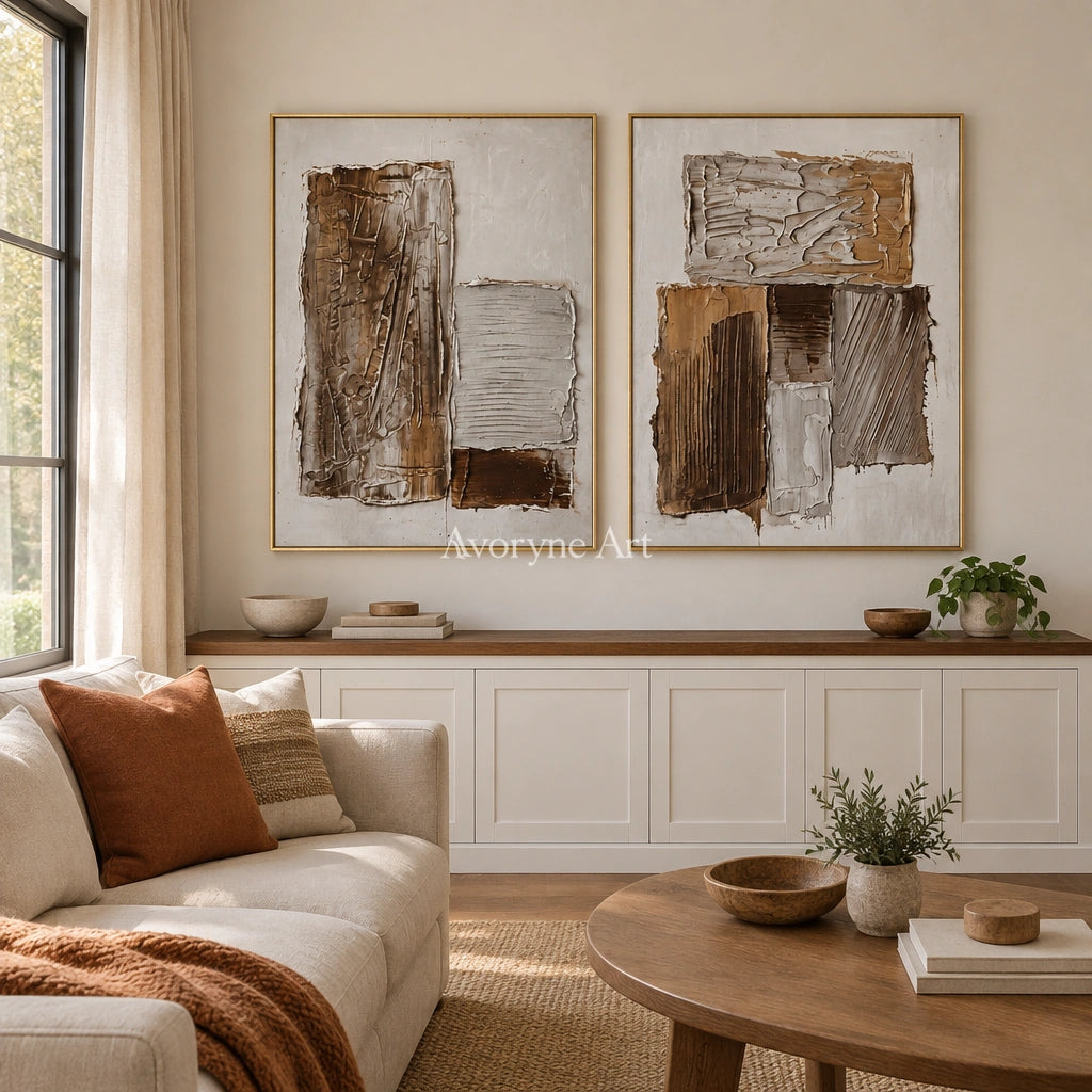 Hushed Gesture neutral geometric relief diptych with a gold frame hanging in a living room