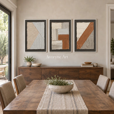 Soft Field neutral geometric relief triptych with a white frame in a dining room