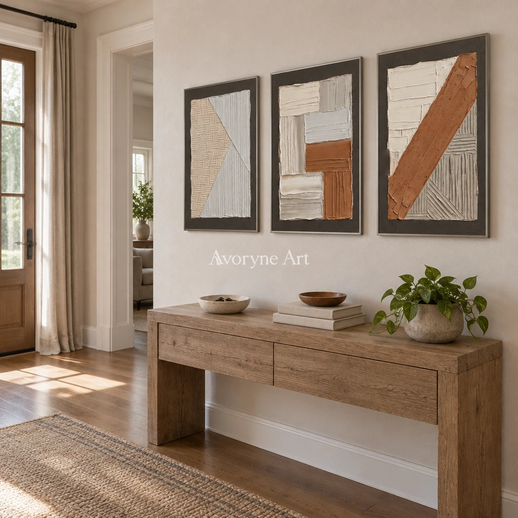 Soft Field neutral geometric relief triptych with a silver frame in an entryway