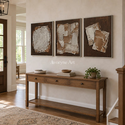 Soft Sonata neutral geometric relief triptych with a silver frame in an entryway