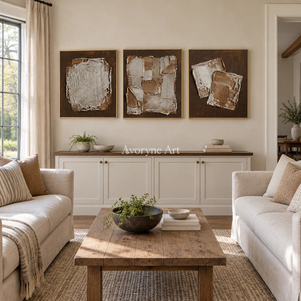 Soft Sonata neutral geometric relief triptych with a gold frame hanging in a living room