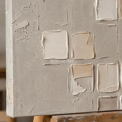 Close-up of the hand-painted texture of Weathered Mosaic neutral grid texture wall art on an easel