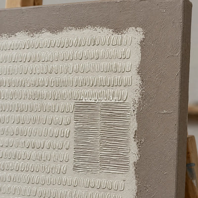Close-up of the hand-painted texture of Woven Mosaic neutral grid texture wall art on an easel