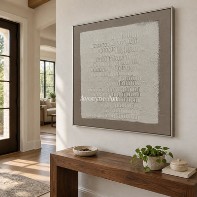 Woven Solace neutral grid texture wall art with a silver frame in an entryway