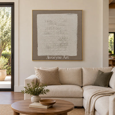 Woven Solace neutral grid texture wall art with a gold frame hanging in a living room