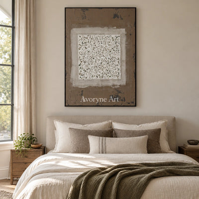 Weathered Measure neutral layered relief wall art with a black frame above a bed in a bedroom