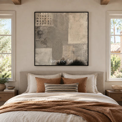 Woven Field neutral mineral texture wall art with a black frame above a bed in a bedroom