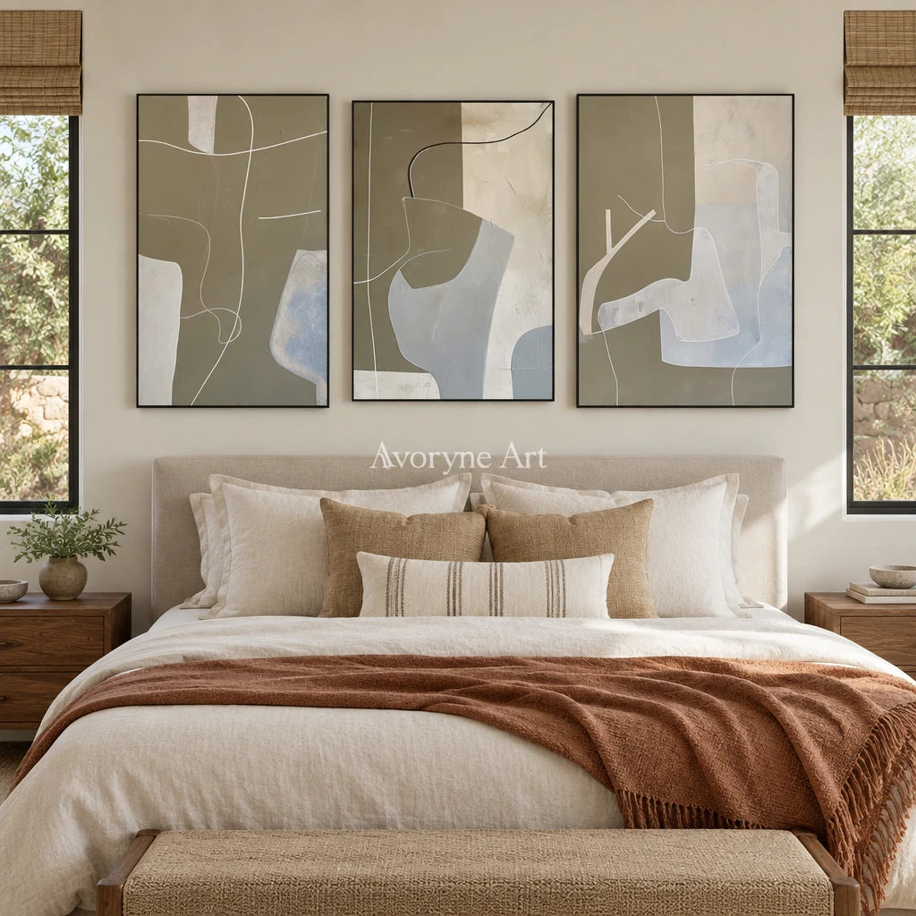 Muted Passage neutral organic art triptych with a black frame above a bed in a bedroom