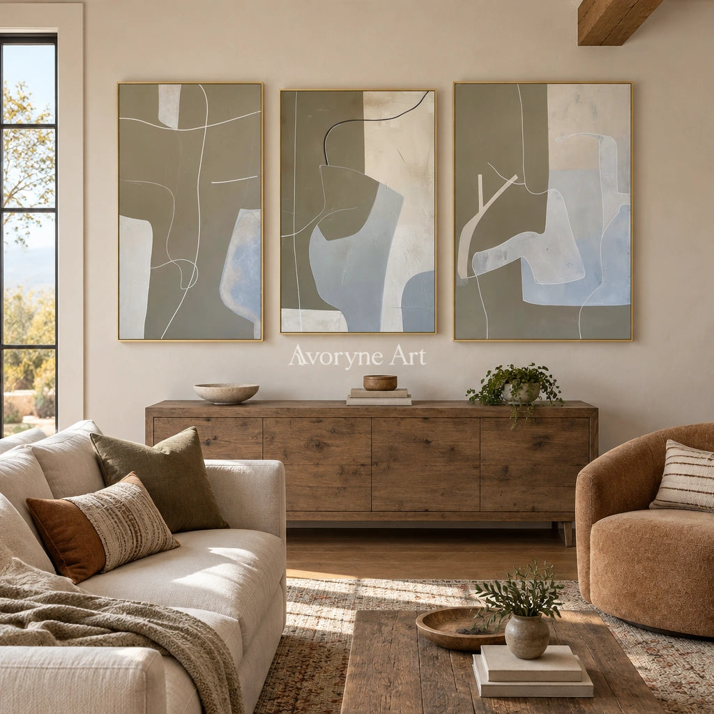 Muted Passage neutral organic art triptych with a gold frame hanging in a living room