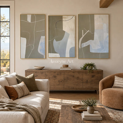 Muted Passage neutral organic art triptych with a gold frame hanging in a living room