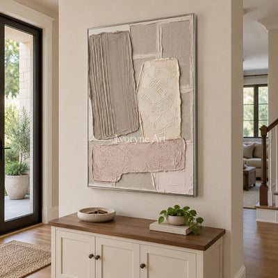 Weathered Haven neutral patch relief wall art with a silver frame in an entryway