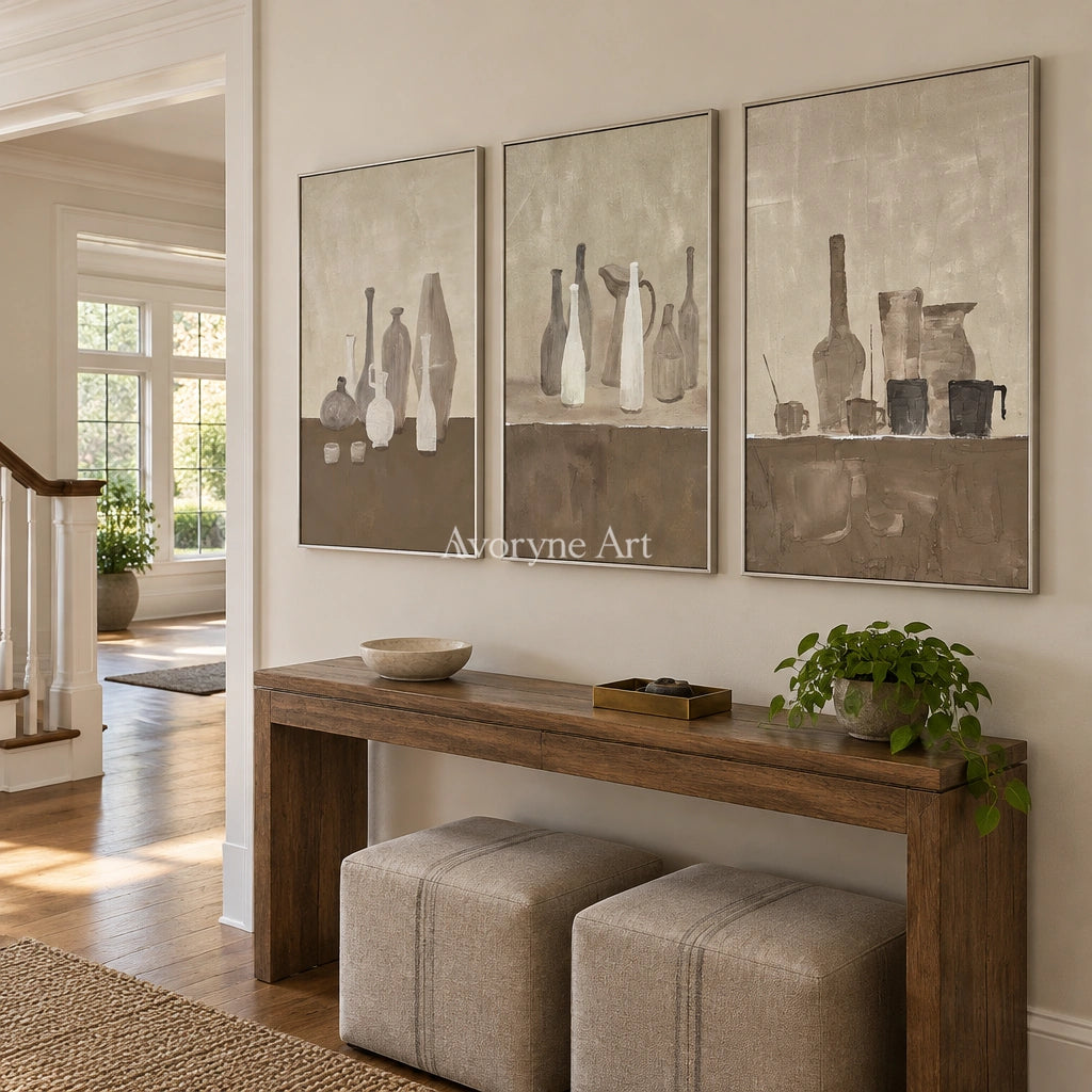 Muted Verse neutral pottery art triptych with a silver frame in an entryway