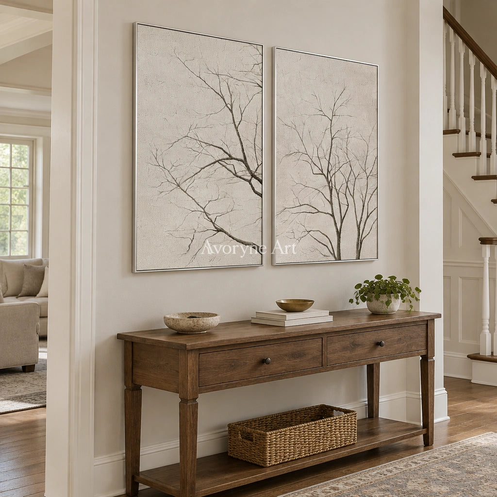 Muted Drift neutral tree texture diptych with a silver frame in an entryway