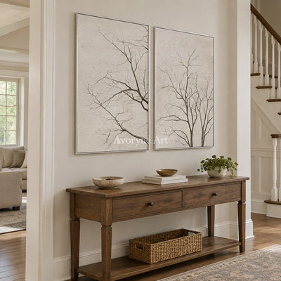Muted Drift neutral tree texture diptych with a silver frame in an entryway