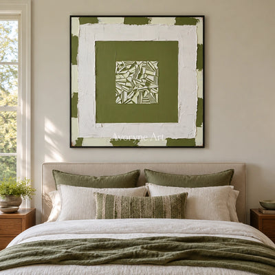 Hushed Trace olive ivory grid wall art with a black frame above a bed in a bedroom