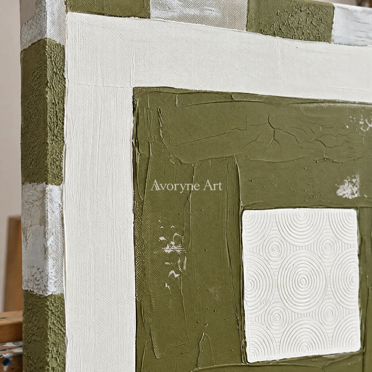Close-up of the hand-painted texture of Hushed Drift olive ivory grid wall art on an easel