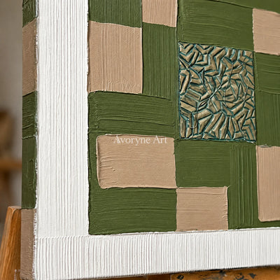 Close-up of the hand-painted texture of Hushed Horizon olive ivory grid wall art on an easel