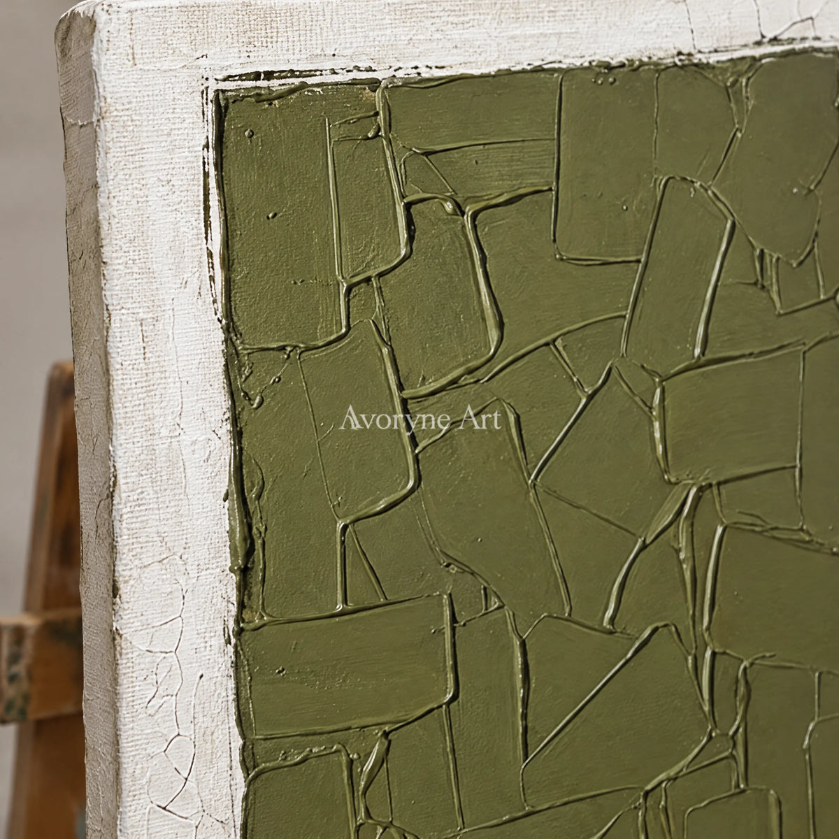 Close-up of the hand-painted texture of Earthen Field olive ivory grid triptych on an easel
