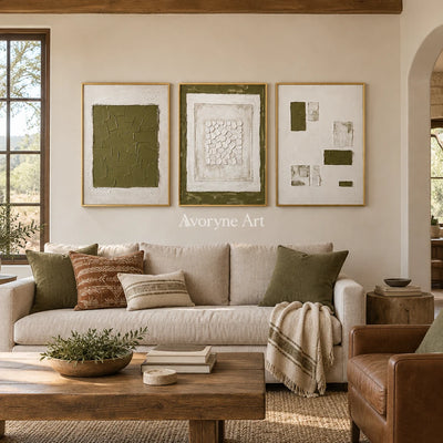 Earthen Field olive ivory grid triptych with a gold frame hanging in a living room