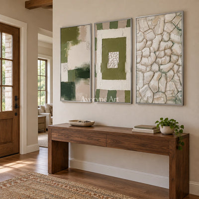 Hushed Cadence olive ivory grid triptych with a silver frame in an entryway