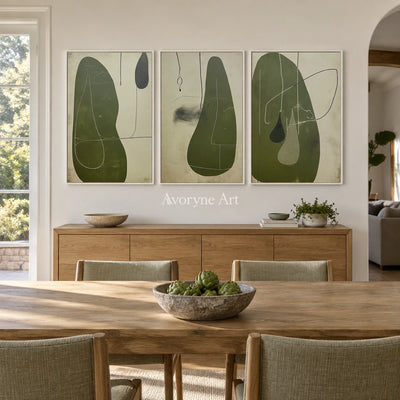 Muted Rhythm olive organic art triptych with a white frame in a dining room