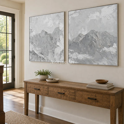 Muted Memory pale mountain relief diptych with a silver frame in an entryway