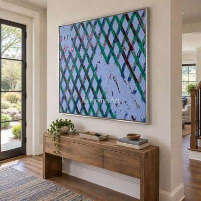 Earthen Haven pastel grid texture wall art with a silver frame in an entryway