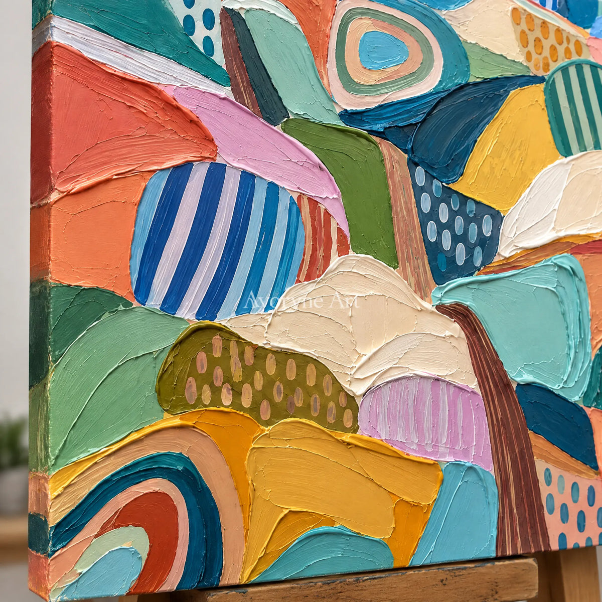 Close-up of the hand-painted texture of Amber Rhythm patterned field wall art on an easel