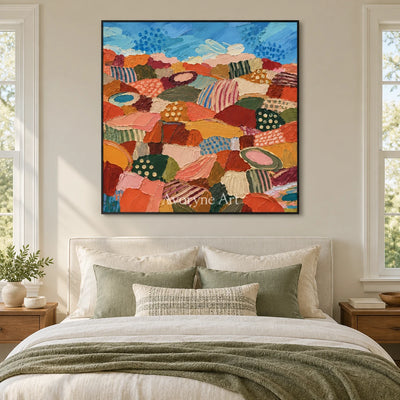 Amber Vista patterned field wall art with a black frame above a bed in a bedroom