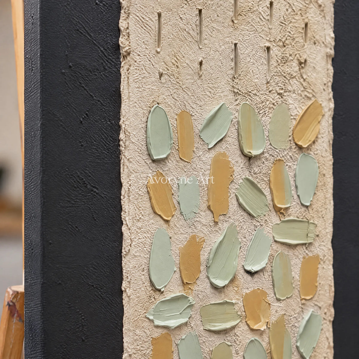 Close-up of the hand-painted texture of Soft Rhythm relief mosaic wall art on an easel