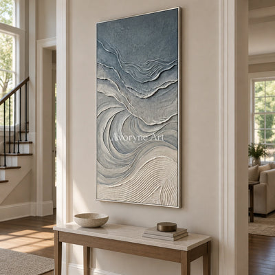 Quiet Dialogue ripple relief wall art with a silver frame in an entryway